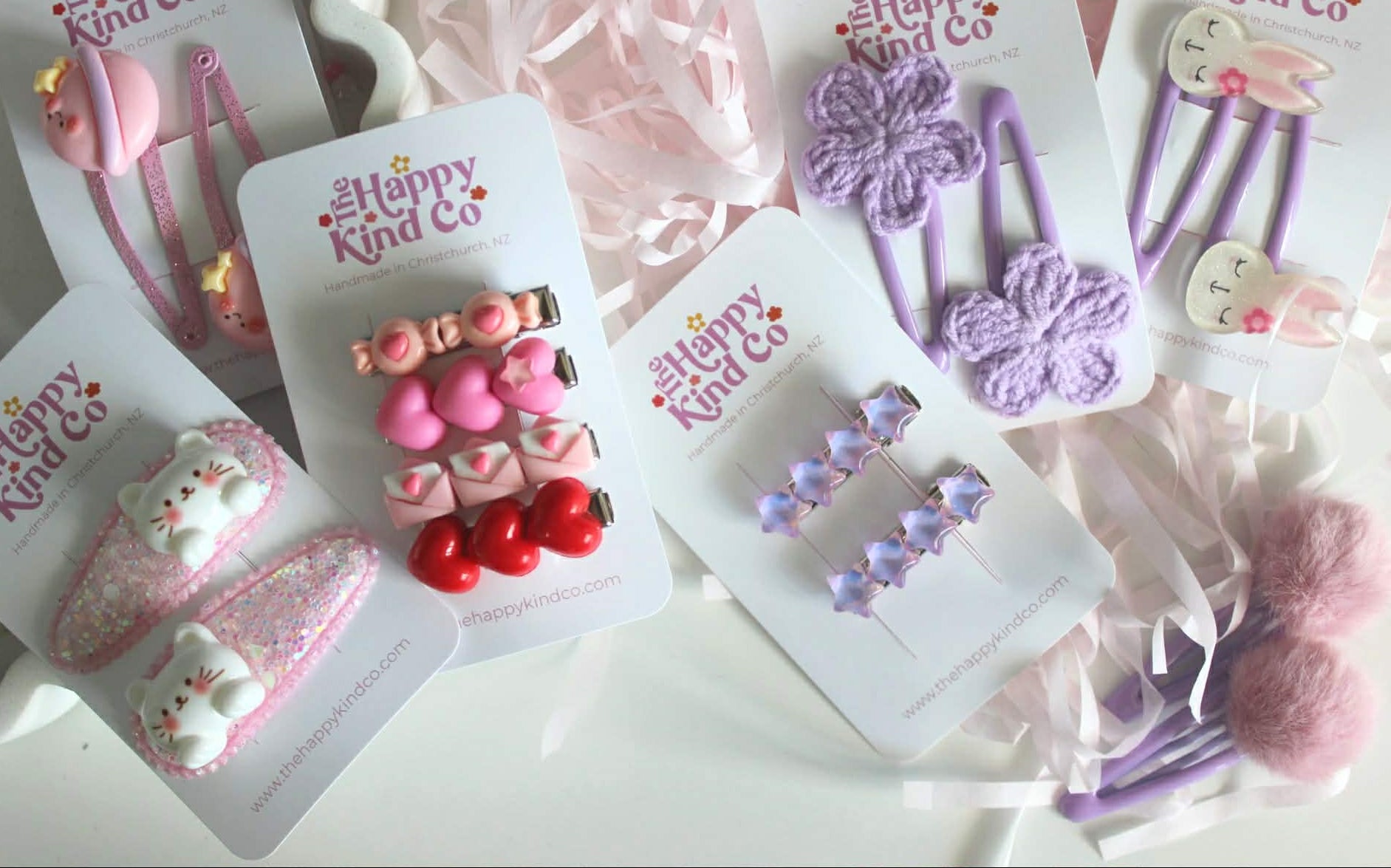 Set of children's hair accessories on cards with 'Happy Kind Co' branding.